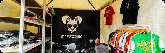 The Rizzed merch stall with jerseys on racks